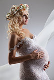 Young Pregnant Woman With Flower Garland