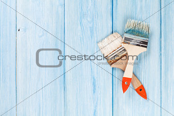 Paintbrush over blue wood