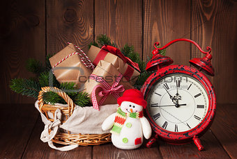 Christmas gifts and tree with alarm clock and snowman