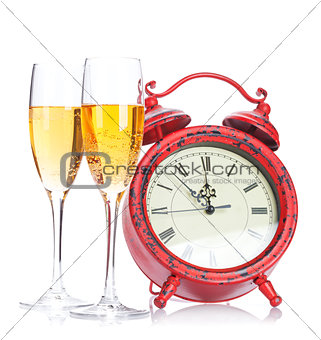 Two champagne glasses and christmas clock