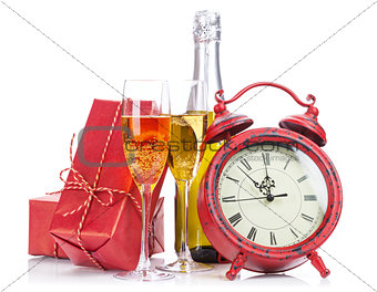 Champagne, christmas gift and alarm clock