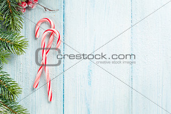 Candy cane and christmas tree on wooden table