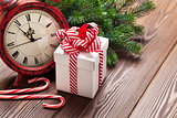 Christmas alarm clock, gift box and fir tree branch