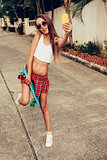 beautiful sexy young lady in erotic mini skirt with a skateboard