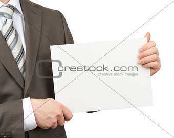 Businessman with blank paper in hands on white