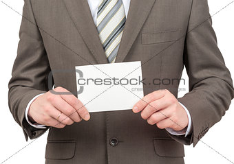 Businessman holding small blank sheet of paper