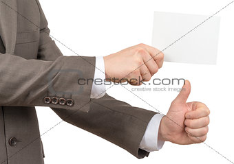 Businessman with small blank card showing sign ok