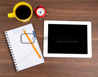 Blank copybook with tablet and alarm clock