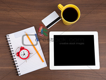 Blank copybook with tablet and alarm clock