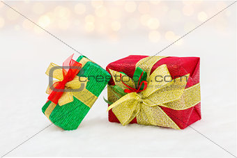 Red and green Christmas gift box with shiny golden ribbon