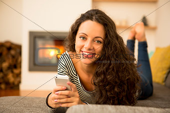 Woman with her cellphone at home