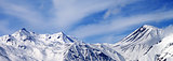 Panoramic view on winter snowy mountains in windy day