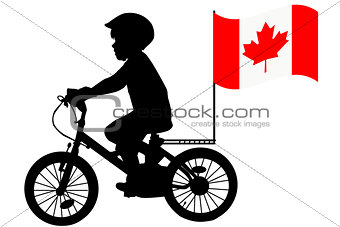 A kid  rides a bicycle with Australia flag