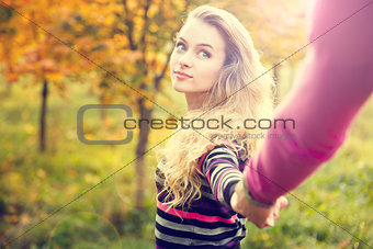 Young Woman Holding Hands on Autumn Background