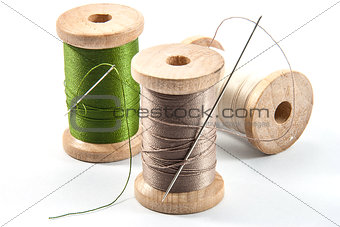 Isolated wooden spools of thread
