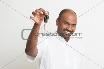 Mature Indian man holding car key