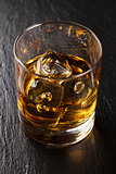 Glass of scotch whiskey with ice