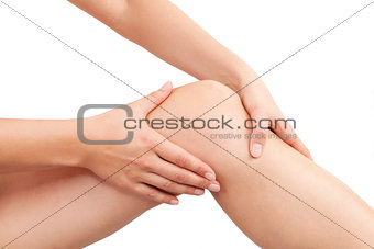 Female hand holding knee isolated.