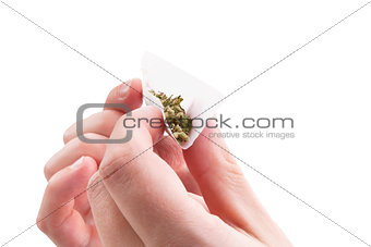 Preparing a cannabis joint.
