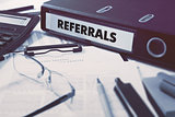 Referrals on Ring Binder. Blured, Toned Image.