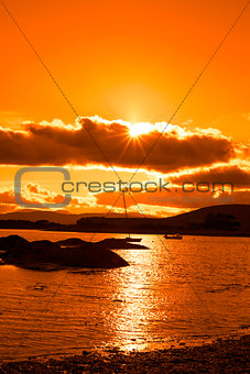 wild atlantic way ireland with an orange sunset