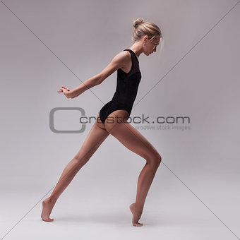 young beautiful dancer in black swimsuit
