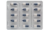 Closeup dark blue and white capsules in medication blister packs