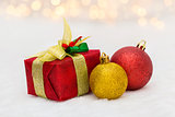 Red Christmas gift box with shiny golden ball