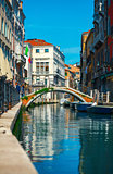Bridge over channel among houses in Venice