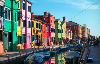 Bright coloured houses on coast of channel in Burano island