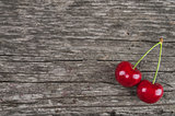 Dual ripe cherry on a vintage wooden background