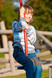 Boy on a Swing in the Playground
