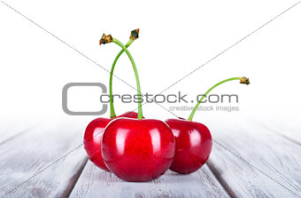 Ripe cherries on wooden table with copy space