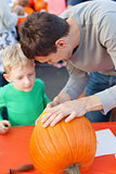 family carving pumpkin