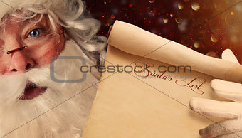 Closeup of Santa Claus holding a Santa List 