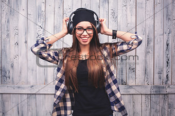 girl in glasses, headphones and black beanie