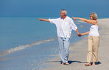 Happy Senior Couple Walking Pointing Holding Hands Beach