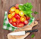 Fresh colorful tomatoes and basil in colander