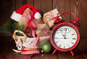 Christmas gifts and tree with alarm clock
