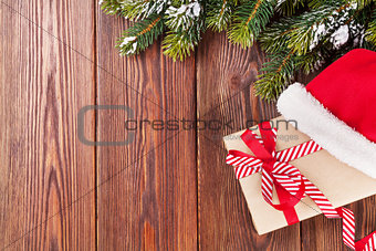 Christmas tree branch and santa hat with gift box