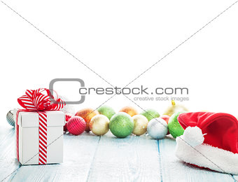 Christmas gift box, santa hat and colorful baubles