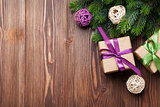 Christmas gift boxes and fir tree on table