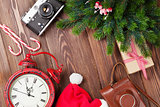 Christmas background with camera, alarm clock and tree branch