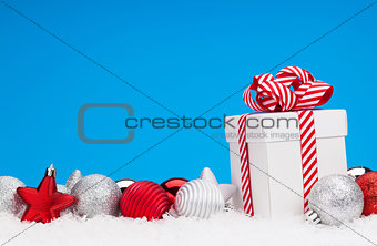 Christmas background with baubles and gift box