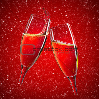 Two champagne glasses over red christmas background