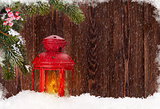 Christmas candle lantern in snow