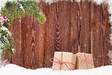 Christmas gift boxes and fir tree branch in snow