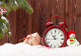 Christmas gift boxes, alarm clock and fir tree branch