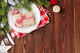 Christmas table setting with gift box and fir tree