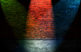 Colorful spot lights on brick wall
